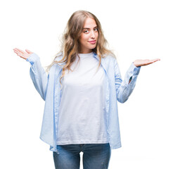 Beautiful young blonde woman over isolated background clueless and confused expression with arms...