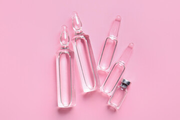 Medical ampules on pink background