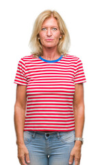 Fototapeta premium Middle age blonde woman over isolated background with serious expression on face. Simple and natural looking at the camera.