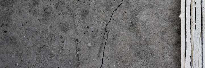 Torn old faded paper wallpaper with a retro pattern. Tattered scraps of paper on a concrete wall. Vintage texture for background and design. Closeup view with copy space.