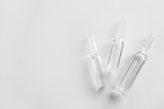 Medical ampules on light background
