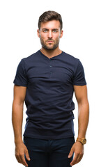 Obraz premium Young handsome man over isolated background with serious expression on face. Simple and natural looking at the camera.