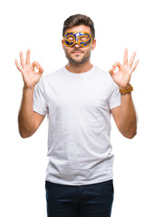 Young handsome man wearing carnival mask over isolated background relax and smiling with eyes closed doing meditation gesture with fingers. Yoga concept.