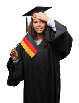 Young hispanic woman wearing graduation uniform holding flag of Germany stressed with hand on head, shocked with shame and surprise face, angry and frustrated. Fear and upset for mistake.