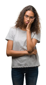 Beautiful young hispanic woman wearing glasses thinking looking tired and bored with depression problems with crossed arms.