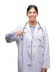 Fototapeta premium Young hispanic doctor woman with surprise face pointing finger to himself