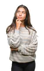 Young beautiful arab woman wearing winter sweater over isolated background with hand on chin thinking about question, pensive expression. Smiling with thoughtful face. Doubt concept.