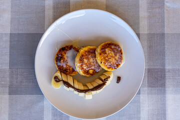 Traditional Ukrainian cheesecakes with bananas and chocolate 