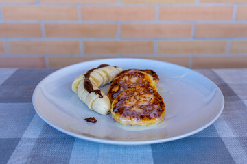 Traditional Ukrainian cheesecakes with bananas and chocolate 
