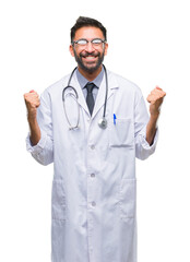 Fototapeta premium Adult hispanic doctor man over isolated background celebrating surprised and amazed for success with arms raised and open eyes. Winner concept.