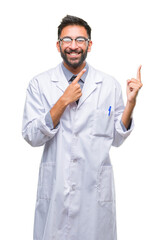 Adult hispanic scientist or doctor man wearing white coat over isolated background smiling and looking at the camera pointing with two hands and fingers to the side.