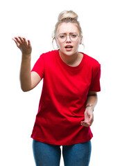 Fototapeta premium Young blonde woman wearing glasses over isolated background angry and mad raising fist frustrated and furious while shouting with anger. Rage and aggressive concept.