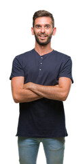 Obraz premium Young handsome man over isolated background happy face smiling with crossed arms looking at the camera. Positive person.