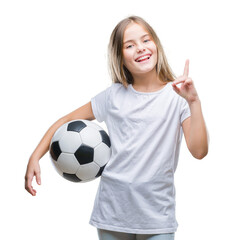 Young beautiful girl holding soccer football ball over isolated background surprised with an idea...