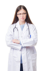 Fototapeta premium Young Chinese doctor woman over isolated background skeptic and nervous, disapproving expression on face with crossed arms. Negative person.