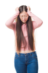 Fototapeta premium Young Chinese woman over isolated background wearing glasses suffering from headache desperate and stressed because pain and migraine. Hands on head.