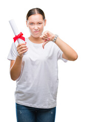 Young caucasian woman holding degree over isolated background with angry face, negative sign showing dislike with thumbs down, rejection concept