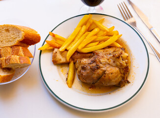 Appetizing braised pork knuckle served with garnish of crispy french fries