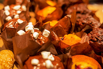 background of hot chocolate muffins sprinkled with marshmallow cubes. Home baking