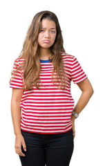 Fototapeta premium Young beautiful brunette woman wearing stripes t-shirt over isolated background depressed and worry for distress, crying angry and afraid. Sad expression.