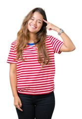 Obraz na płótnie Canvas Young beautiful brunette woman wearing stripes t-shirt over isolated background Smiling pointing to head with one finger, great idea or thought, good memory