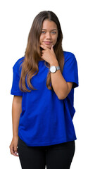 Young beautiful brunette woman wearing blue t-shirt over isolated background looking confident at the camera with smile with crossed arms and hand raised on chin. Thinking positive.