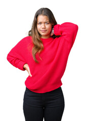 Young beautiful brunette woman wearing red winter sweater over isolated background Suffering of neck ache injury, touching neck with hand, muscular pain