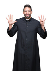 Fototapeta premium Young Christian priest over isolated background showing and pointing up with fingers number nine while smiling confident and happy.