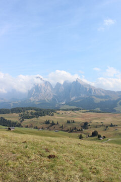 Mountainous landform near green meadow
