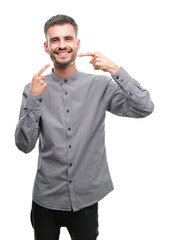 Fototapeta premium Young hipster man smiling confident showing and pointing with fingers teeth and mouth. Health concept.