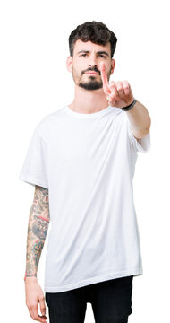 Young handsome man wearing white t-shirt over isolated background Pointing with finger up and angry expression
