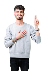 Young handsome man wearing sweatshirt over isolated background Swearing with hand on chest and...