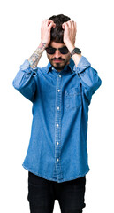 Young handsome man wearing sunglasses over isolated background suffering from headache desperate and stressed because pain and migraine. Hands on head.