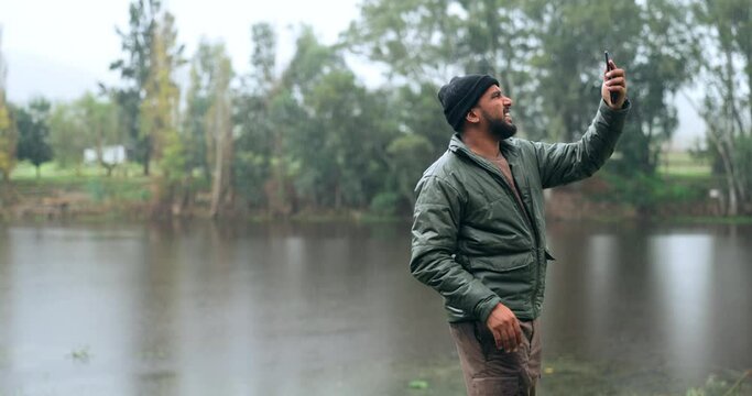 Network, forest and man with bad phone signal and in fear and in the raining woods with a cellphone glitch or 404 error. Emergency, lost and hiker or person with mobile connection problem or issue