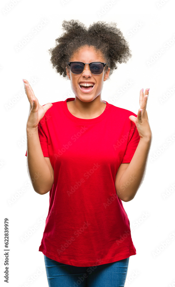 Canvas Prints Young afro american woman wearing sunglasses over isolated background crazy and mad shouting and yelling with aggressive expression and arms raised. Frustration concept.