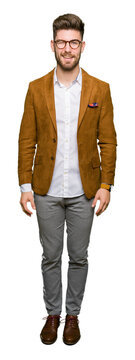 Young handsome business man wearing glasses winking looking at the camera with sexy expression, cheerful and happy face.