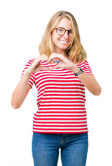 Beautiful young woman wearing glasses over isolated background smiling in love showing heart symbol and shape with hands. Romantic concept.
