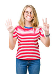 Fototapeta na wymiar Beautiful young woman wearing glasses over isolated background showing and pointing up with fingers number eight while smiling confident and happy.