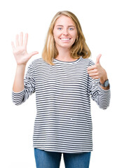 Fototapeta na wymiar Beautiful young woman wearing stripes sweater over isolated background showing and pointing up with fingers number six while smiling confident and happy.
