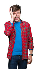 Young handsome student man wearing glasses over isolated background doing ok gesture with hand smiling, eye looking through fingers with happy face.