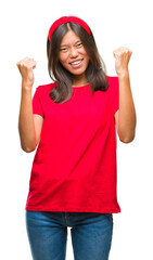 Obraz na płótnie Canvas Young asian woman over isolated background very happy and excited doing winner gesture with arms raised, smiling and screaming for success. Celebration concept.