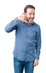 Fototapeta premium Handsome middle age elegant senior man over isolated background smiling doing phone gesture with hand and fingers like talking on the telephone. Communicating concepts.