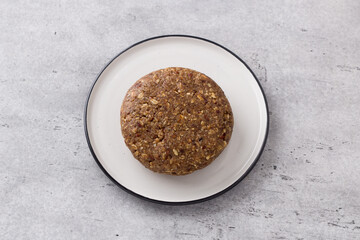 Dough for healthy gluten free oatmeal cookies on gray textured background, top view