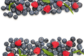 Ripe raspberry and blueberry on white background