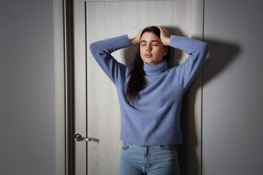 Young Woman Having Panic Attack At Home