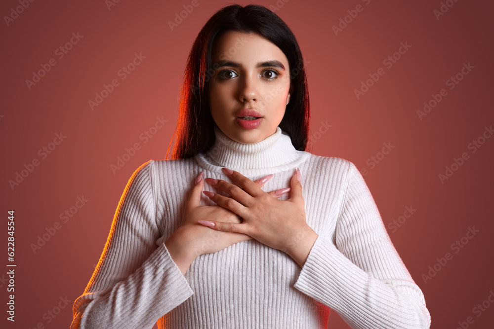 Wall mural Young woman having panic attack on pink background