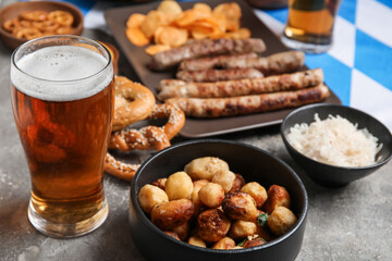 Glass of cold beer and fried potato on grunge background. Oktoberfest celebration