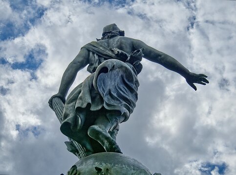 A low angle, rear view of the statue of Marianne, in the Place de la Nation, Paris, France.