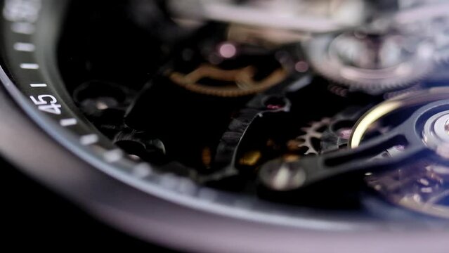 Gear drive motion in skeleton watch. Mechanical watches with gears and cogs. Watch or clock mechanism. Clockwork details and parts. Inside watch, mechanical watch in macro view.Macro Shot Clock Face.