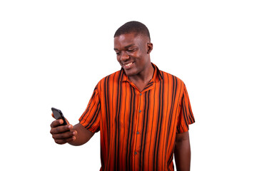 A young African man uses his smartphone and smiles, model isolated on transparent background